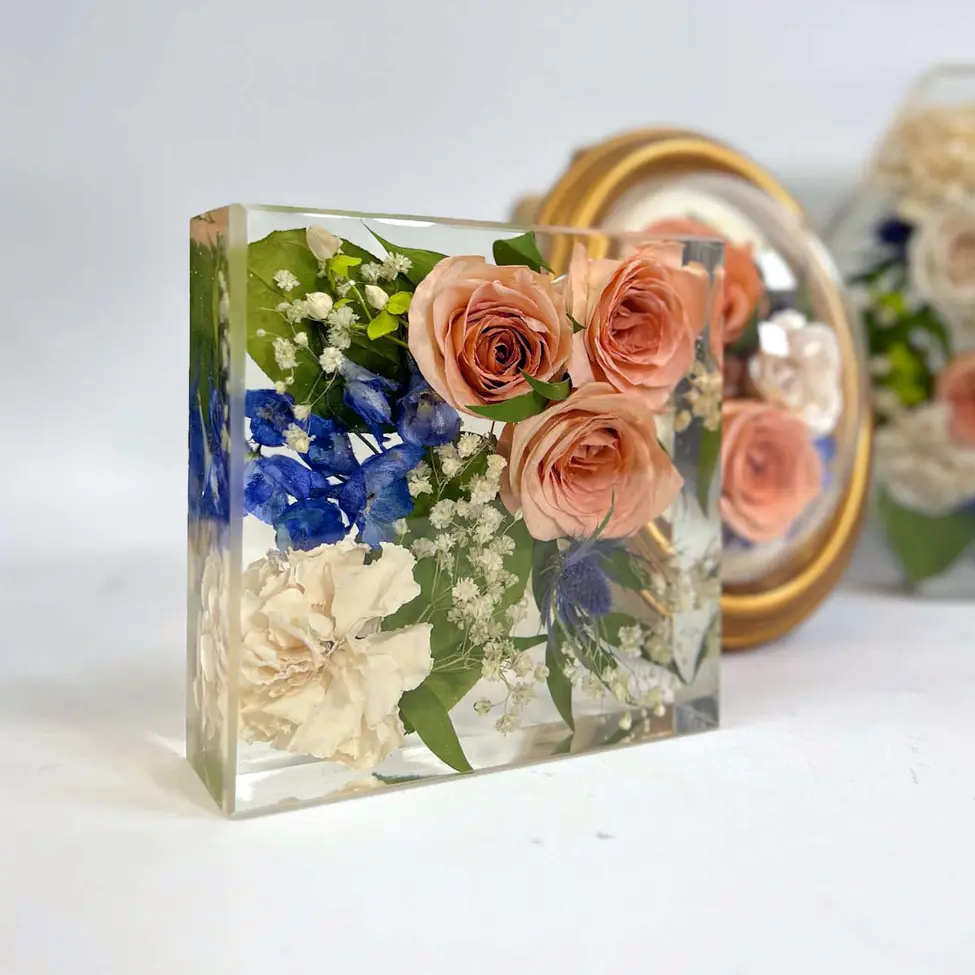 Resin tablet with blush roses and vibrant blue accents