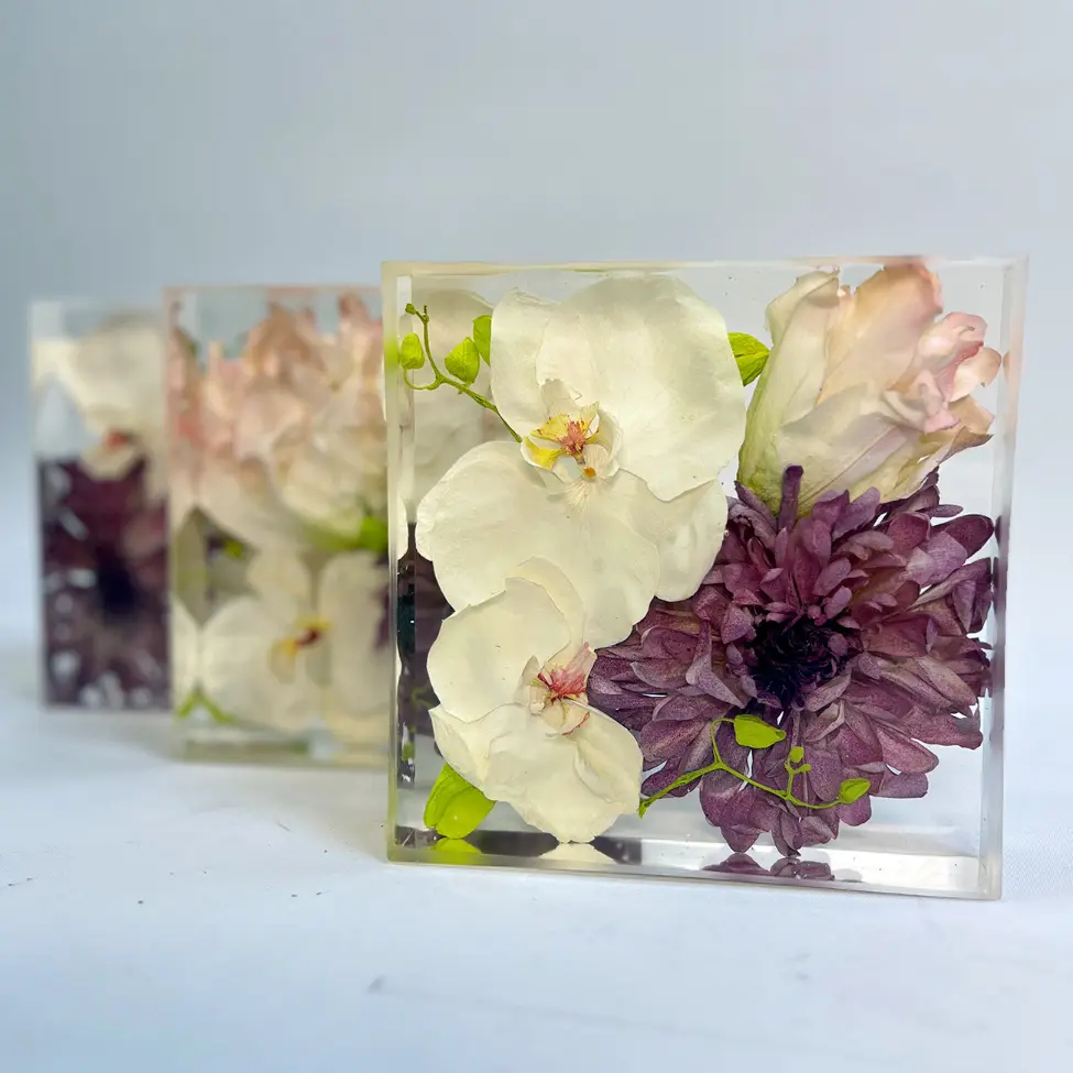 Resin keepsake featuring orchids and deep plum florals