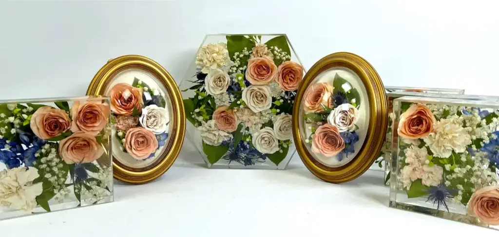 A collection of keepsake designs including twin oval frames, a resin hexagon, and two resin tablets.
