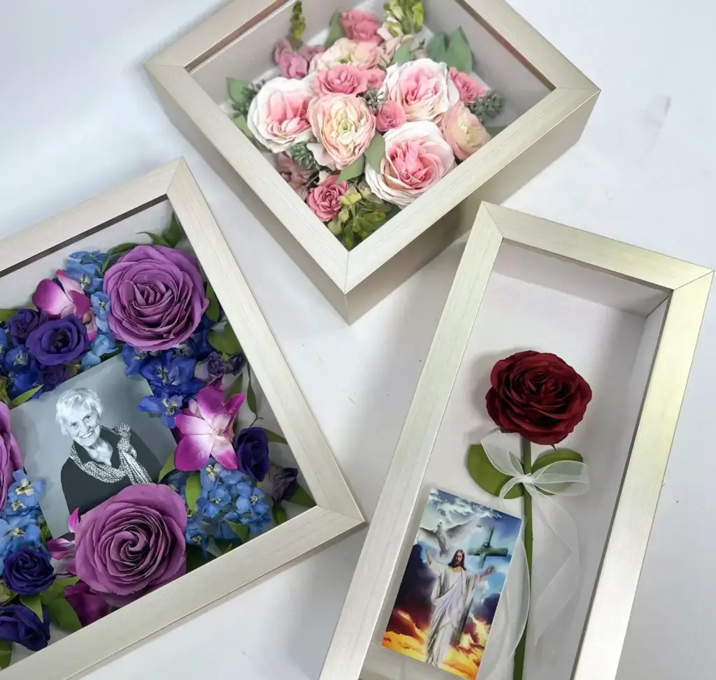 Preserved wedding flowers displayed in modern white shadowbox frames with roses and keepsake photos